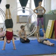people training partner acrobatics with a coach at the NECCA studio in the cotton mill