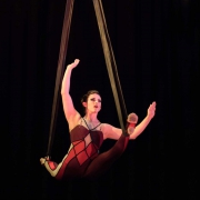 photo of a woman performing a split on aerial straps