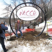 photo of the NECCA sign being raised at the new site